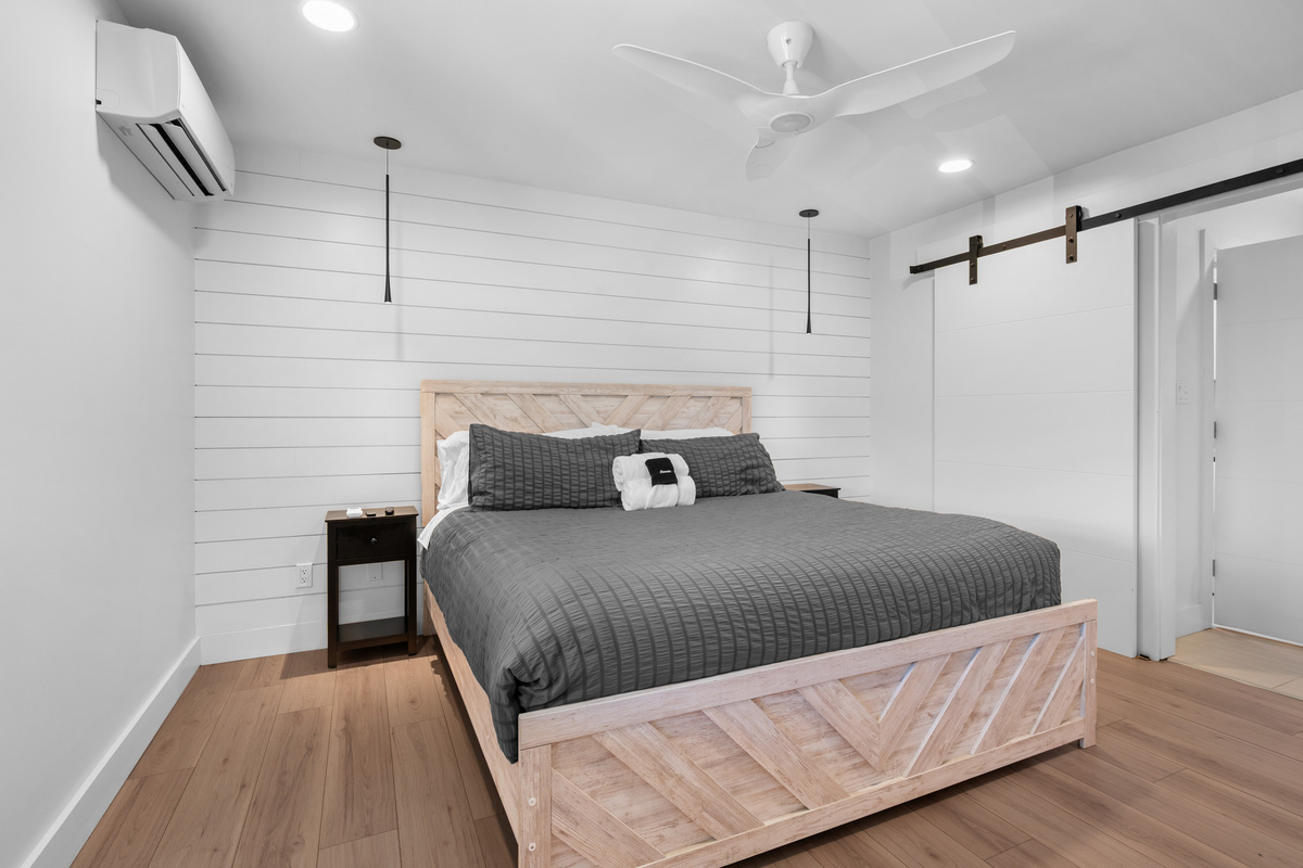 Bright and inviting primary suite featuring a King bed and stylish barn-door accents.