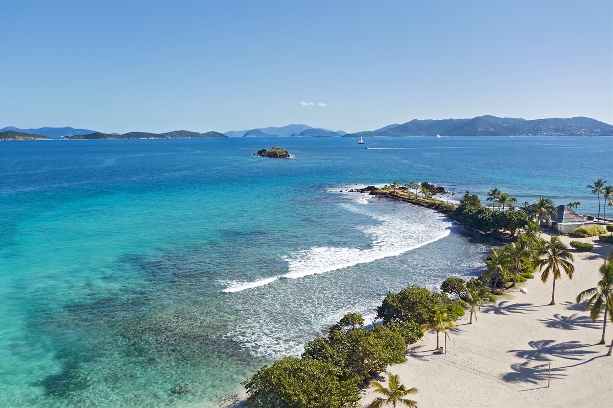 Experience the beauty of the Caribbean from above with sweeping views of the shoreline and endless blue water.