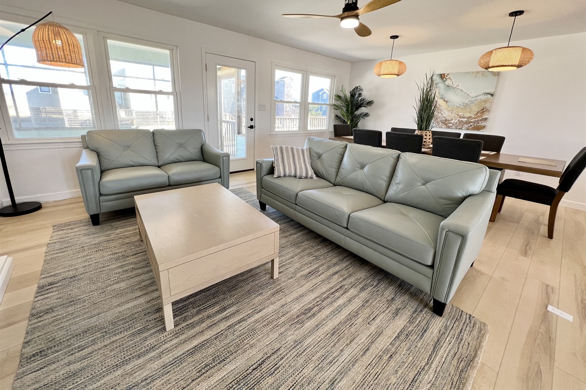 Comfy couches in front of the large coffee table and 58" Roku TV