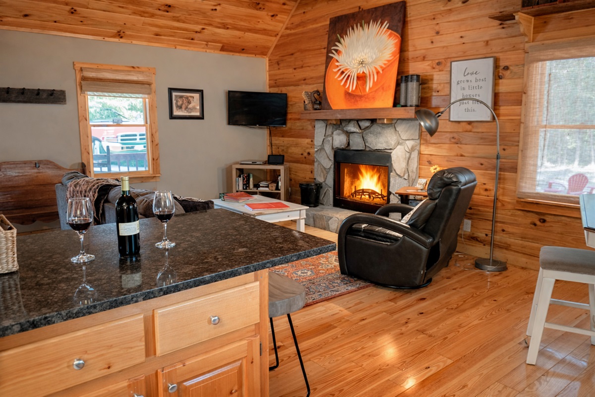 Wine, a warm fire, and cozy cabin comfort—your perfect mountain evening starts right here.
