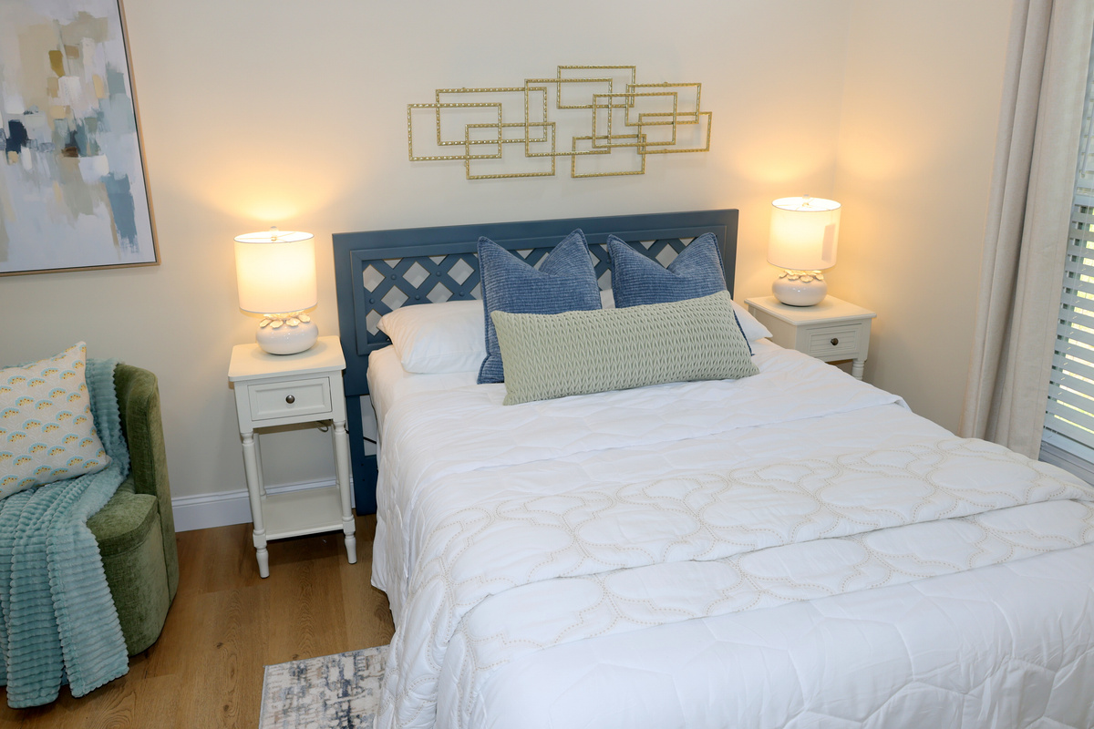 Comfortable bedroom with soft bedding, bedside lighting, and relaxing lake-house style