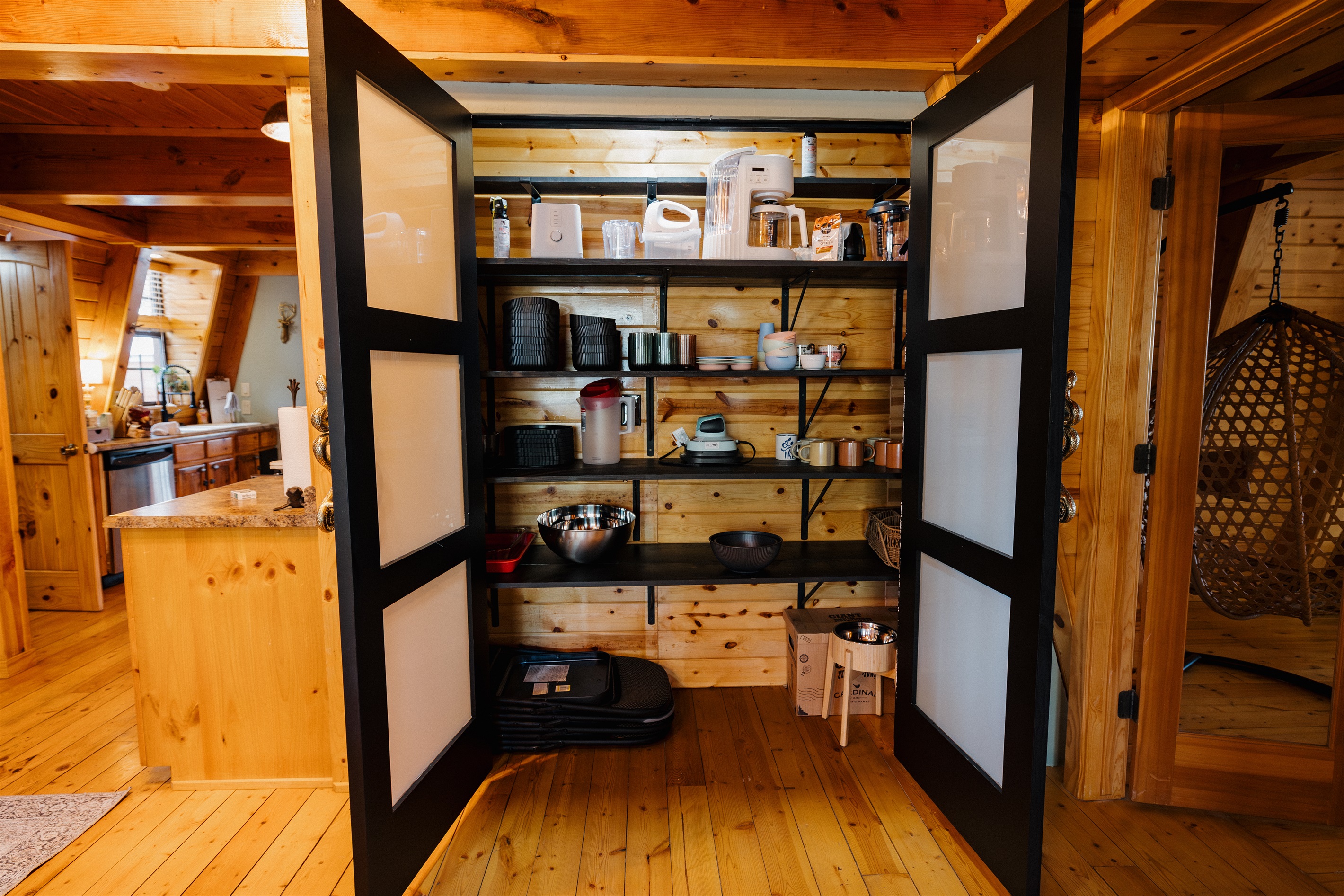 Poppywood Pines’ huge pantry features open shelving, coffee and tea essentials, serving ware, and ample storage—perfect for morning coffee, family meals, and extended stays in this thoughtfully stocked White Mountain cabin.