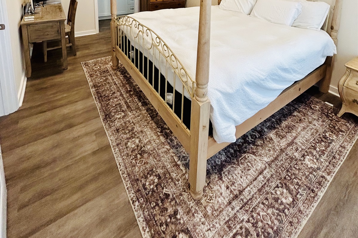 A comfortable and stylish 4 corner post bed in the master