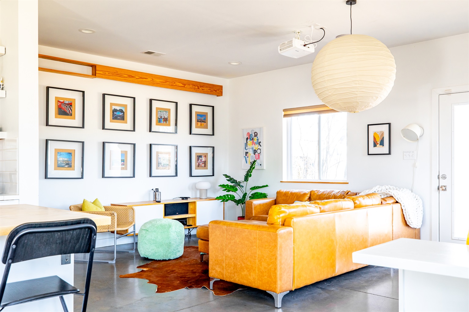 The projector screen drops from the wooden valence above the framed photos!