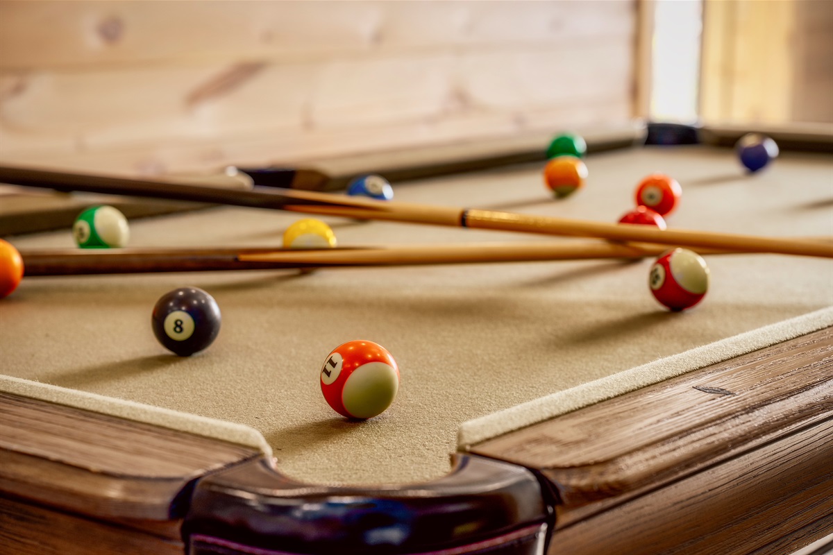 Classic pool table for tournaments, laughs, and after-dinner games.