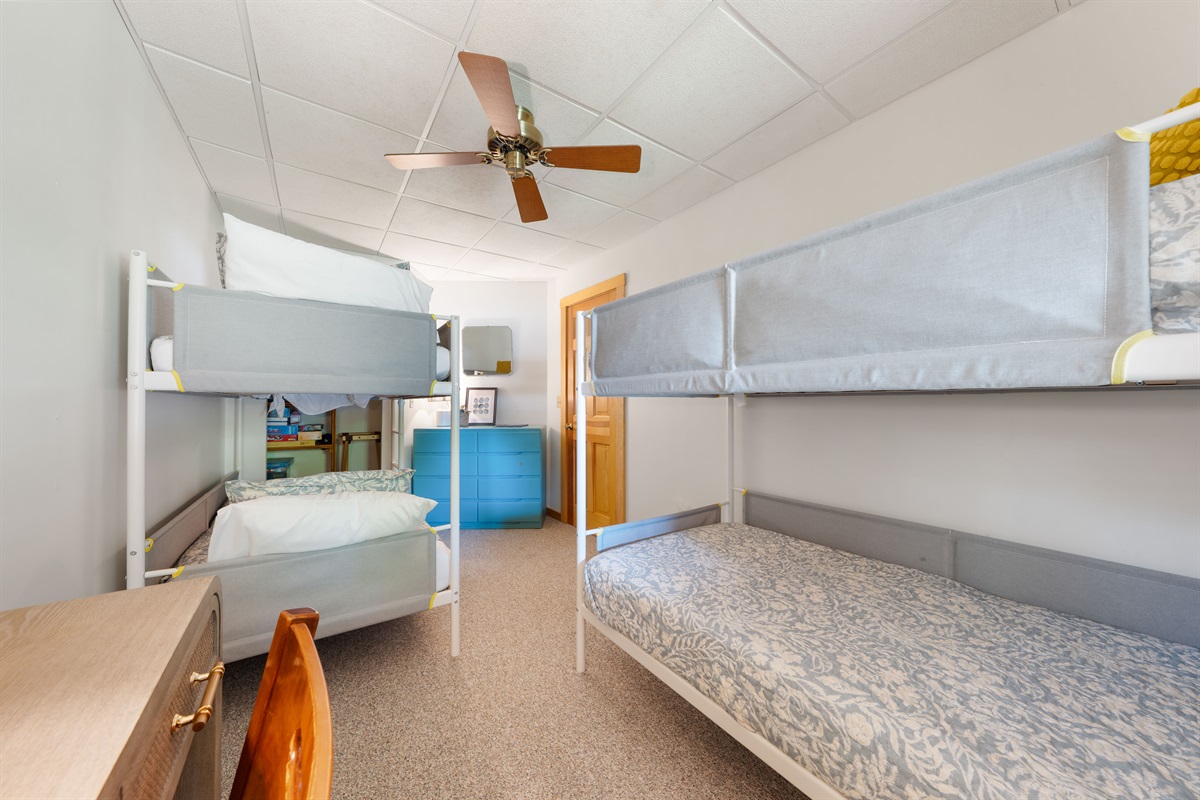 The lower-level bunk room features two twin bunk beds and plenty of storage with a dresser and luggage racks. A full bathroom is just down the hall for your convenience. 