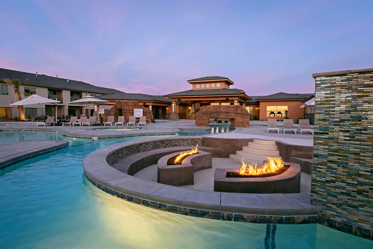 Heated Pool with Curved Fire Features at Twilight
