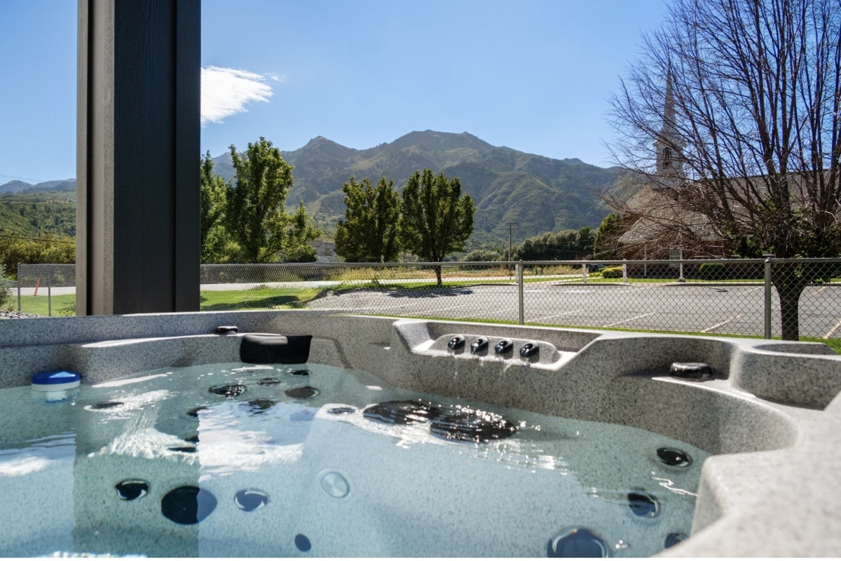 Soak in the private hot tub while taking in the beautiful Mountain Green scenery after a full day of adventure.