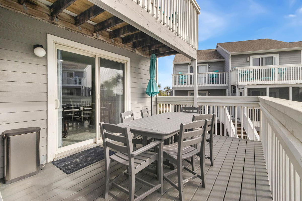 Pull a chair out here after dinner. The deck furniture is built for the Gulf air &mdash; fade-resistant and always comfortable regardless of weather.