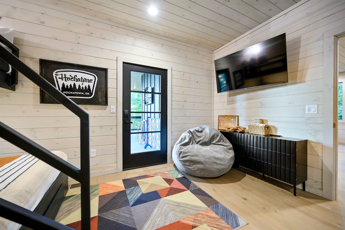 55" TV in the bunk room is a great place to relax and watch a show or movie.  Also, the bean bag chair converts to a floor mattress, perfect for one more place to sleep.