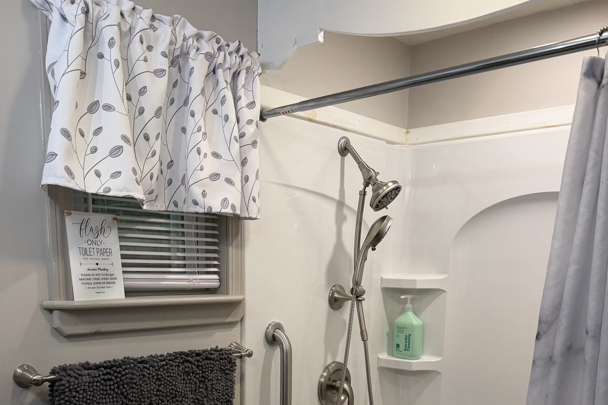 Main level bathroom off hallway w/ shower
