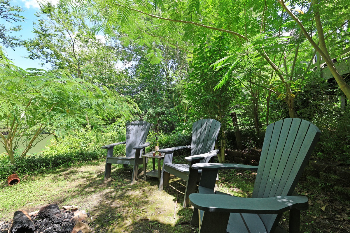 Fire pit area behind the house with river views
