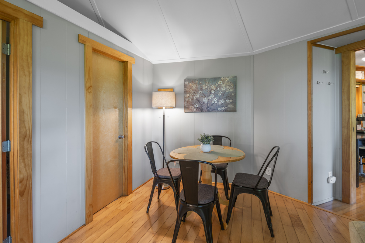 Dining table and 4 chairs in the main round room of the house.