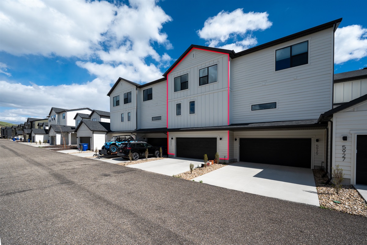 Exterior view highlighting garage access and modern design.