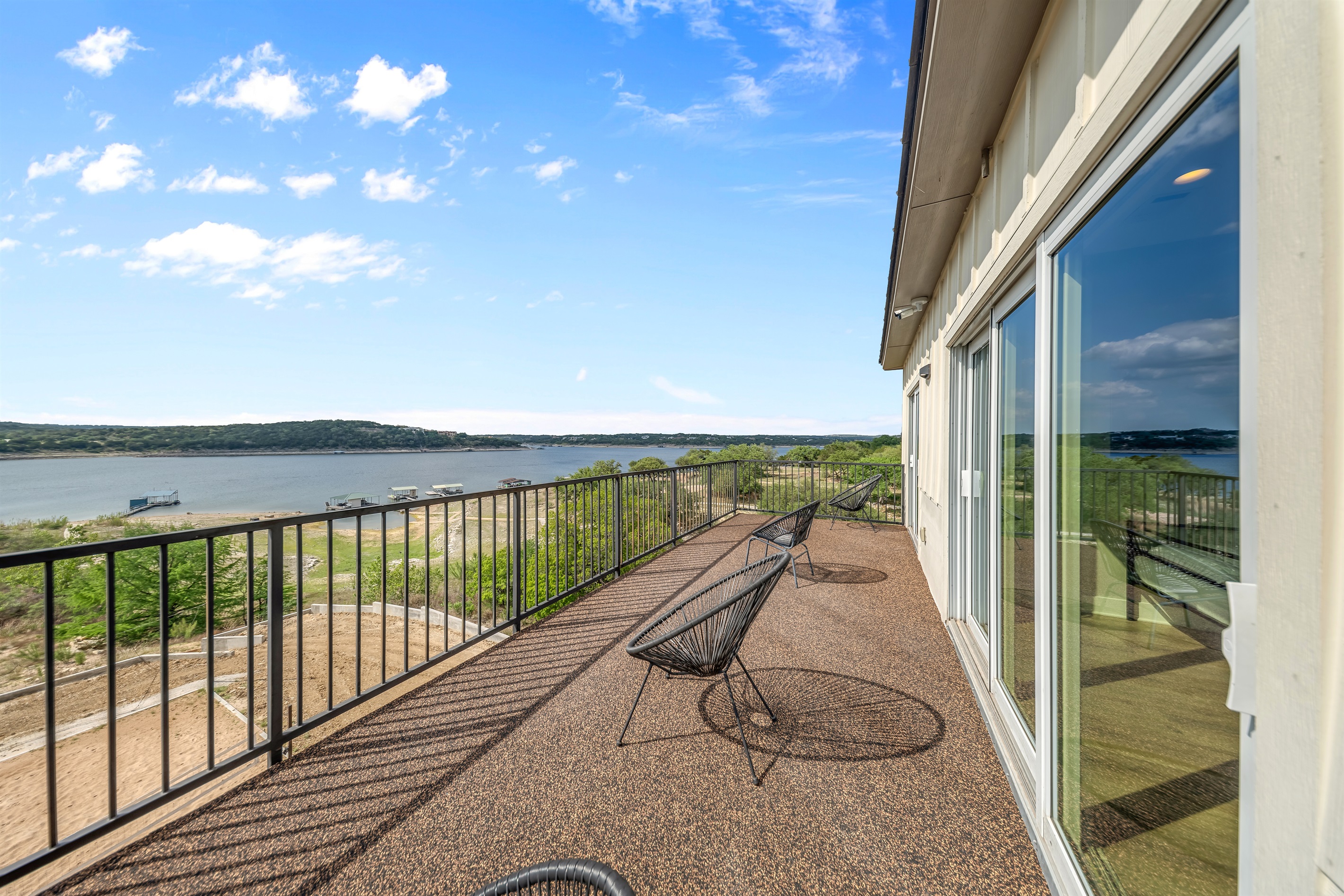 - Upper balcony with panoramic lakeview ideal for quiet relaxation - Bright open outdoor space invites peaceful sunrise and sunset time - Sliding glass doors connect indoor living to scenic views