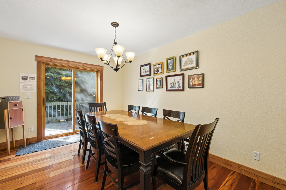 Dining for 8 with an additional leaf and two additional chairs to seat 10. Balcony with gas grill and hot tub seen behind dining table. 