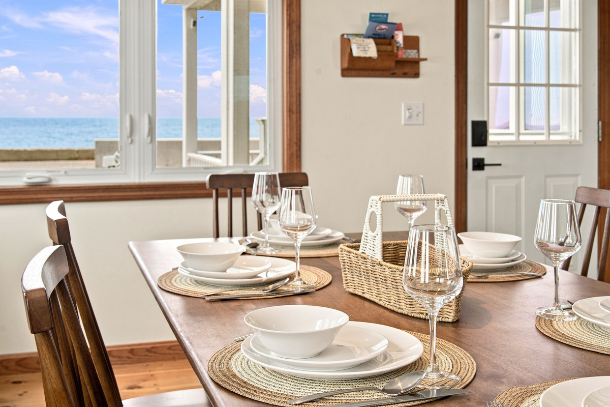 Gather around the dining table and enjoy meals with natural light and scenic coastal views.