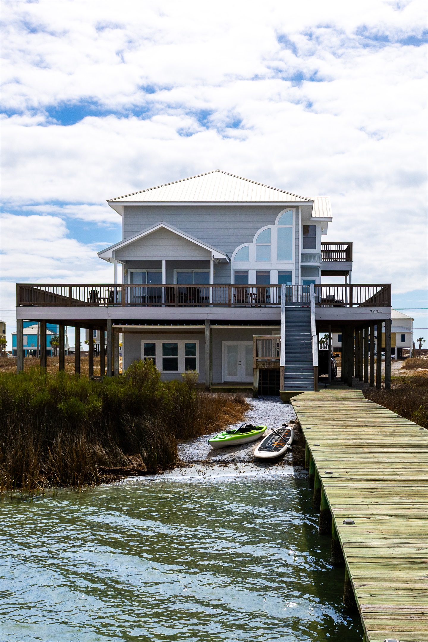 Back of home with private dock and beach faces Lagoon