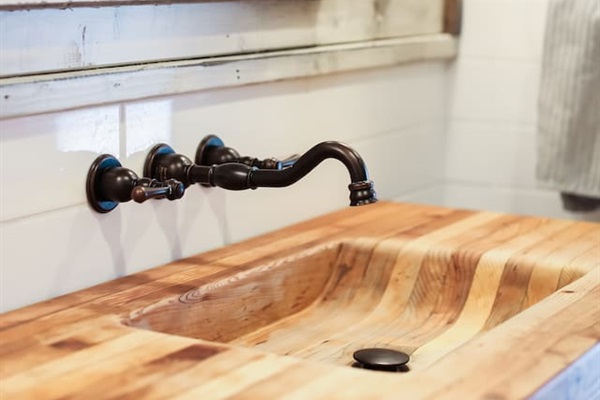 Custom sink upcycled from a butcher's block with hand-carved basin