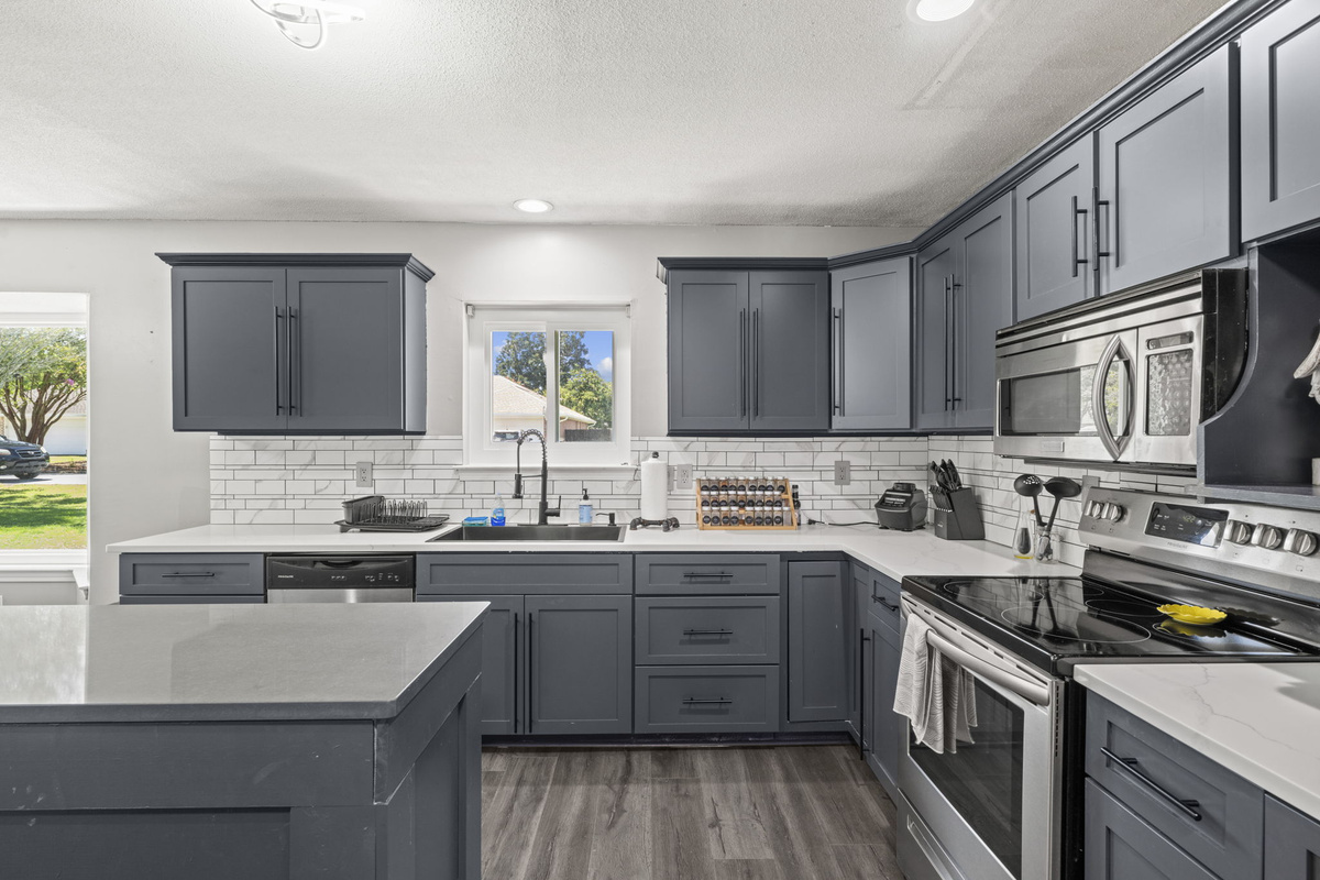 Loads of counter space and cabinet storage give this kitchen an open, functional feel for cooking at any scale.