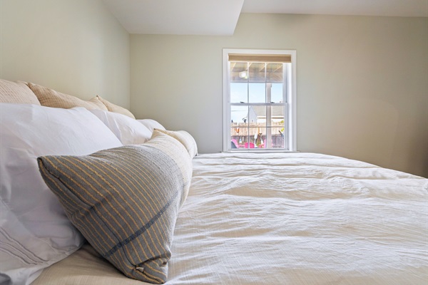 Here’s the second bedroom in our basement, complete with a spacious king bed for ultimate comfort and relaxation