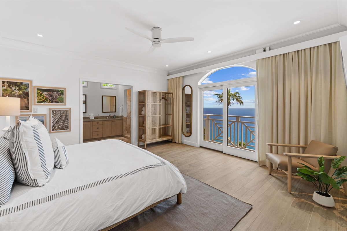 Primary suite with AC, king bed, en-suite bath, large windows, and ocean views. Ideal for privacy and relaxation.