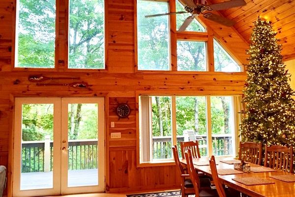 Great Room: Experience serene nature views through grand windows in this stunning wooden retreat!