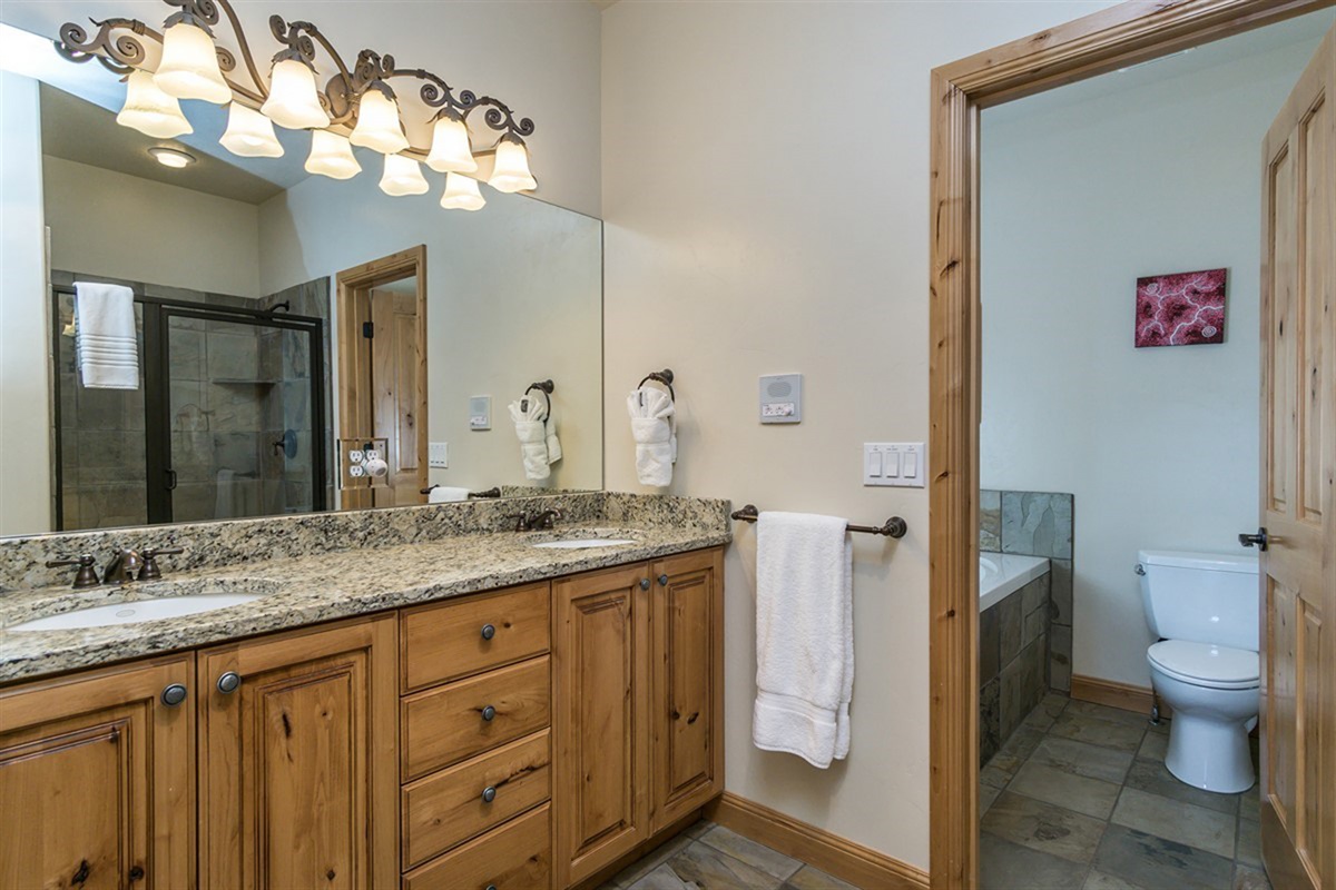 A dual vanity bathroom with ample space and elegant lighting, perfect for shared use without sacrificing comfort.