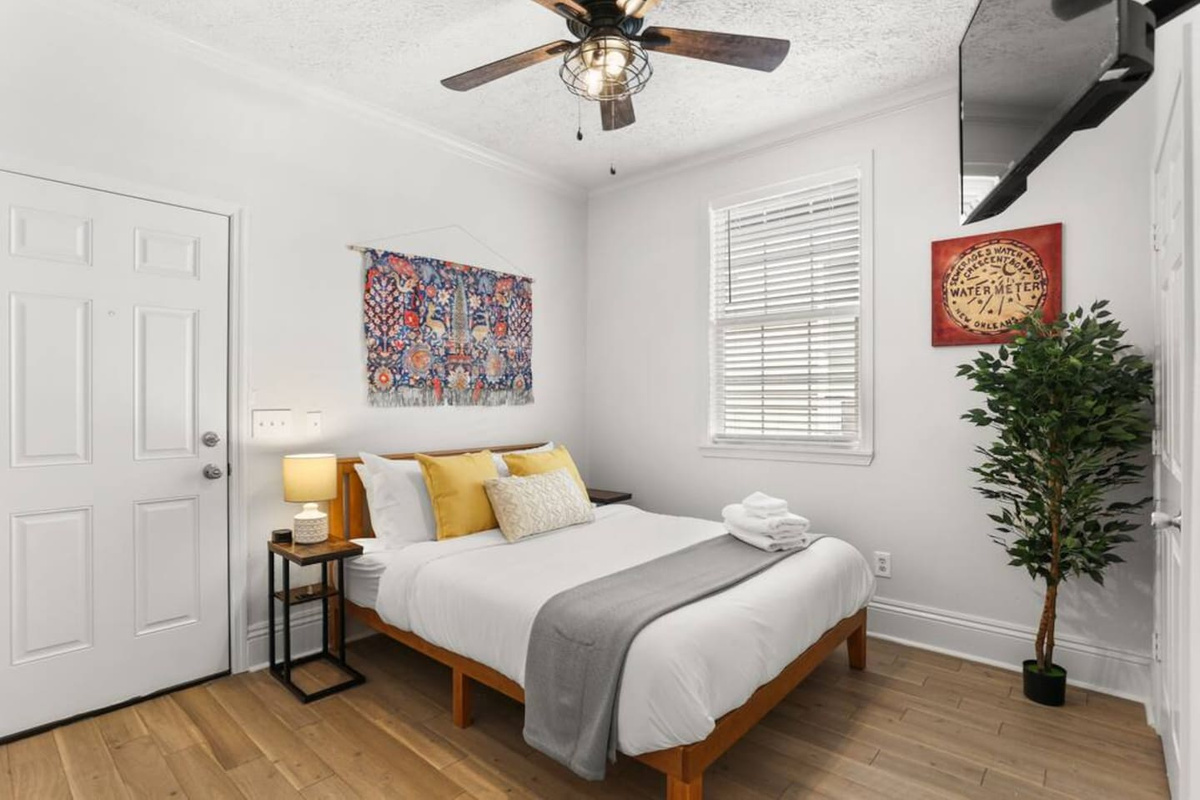 Master bedroom with queen bed, en suite bath, Roku TV & direct access to porch, yard, and cowboy pool!