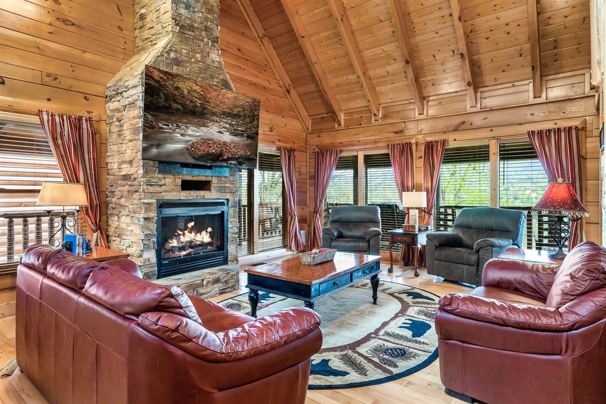 Living room with 75" TV as you walk in the front door.(Fireplace is electric and for decorative purposes only).