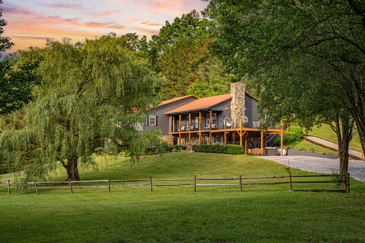 Exterior Retreat: Explore this charming home surrounded by lush greenery and stunning mountain views!