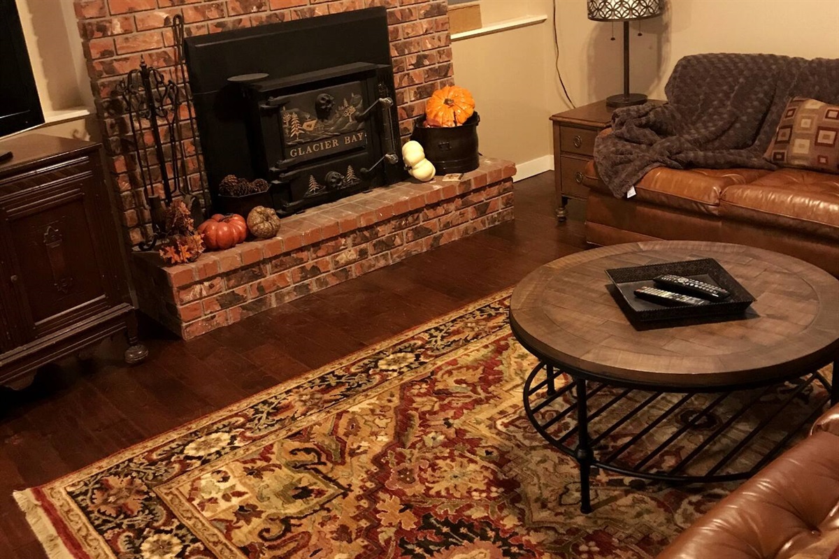 Family room downstairs with wood-burning fireplace and a smart TV