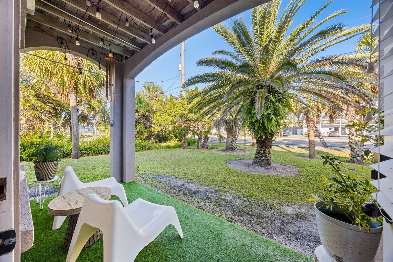 Relaxing porch with garden view and string lights.  Perfect for morning coffee or drinks in the evening.