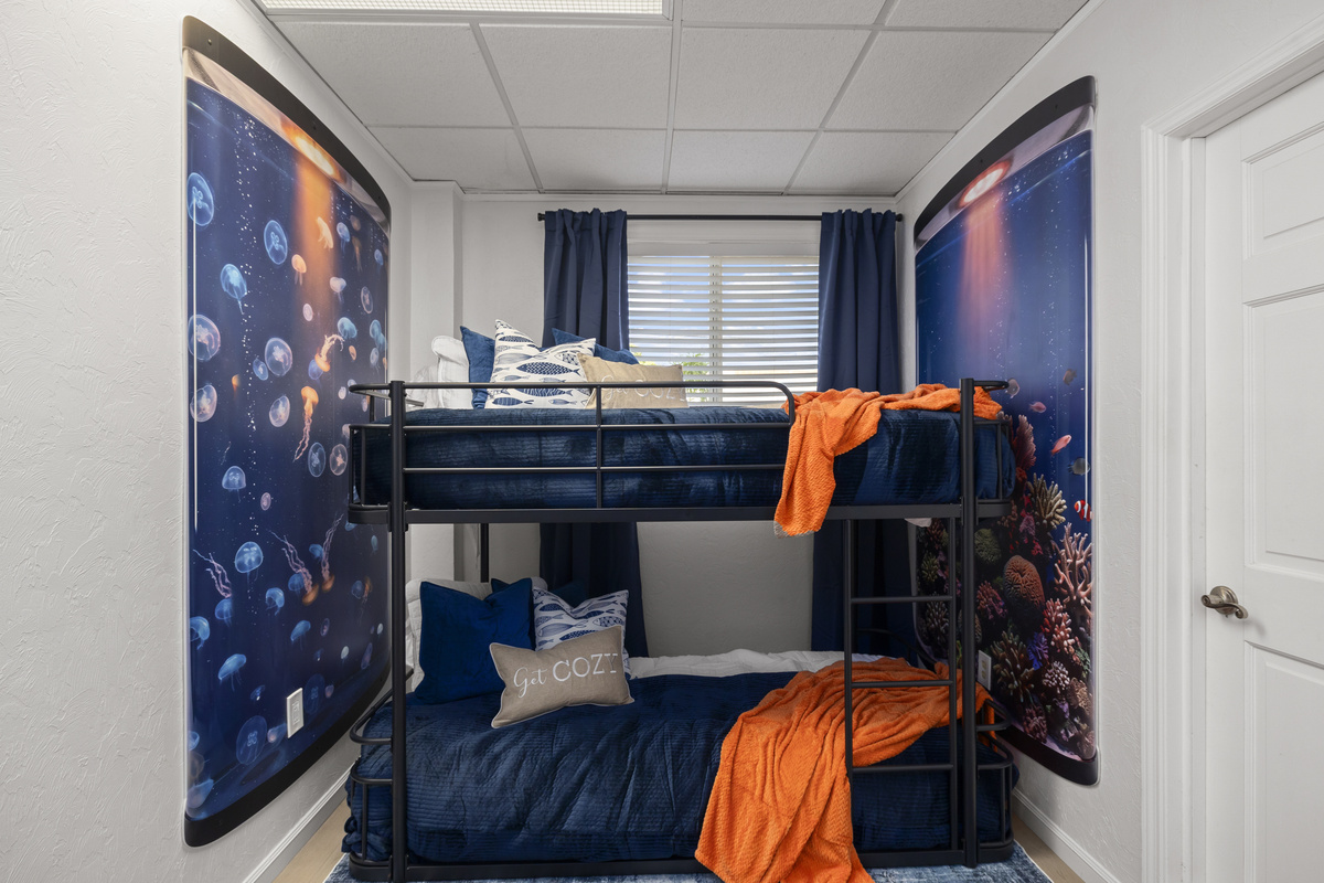 The fourth bedroom is the Aquarium room, including queen bunk beds and twin bunk beds, sleeping up to 6 people comfortably.