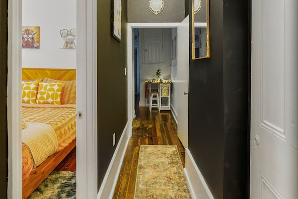 The contrast of rugged original wood floors and modern lighting and design creates a time-traveling vibe, blending the past with the present.