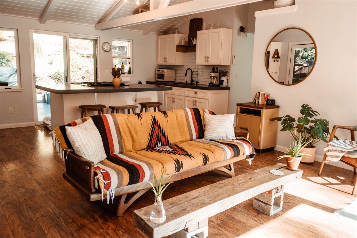 Open-plan living area with stylish furnishings, natural light and a comfortable vibe for two.