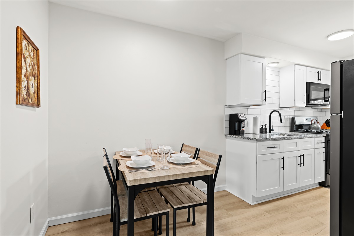 Enjoy meals and morning coffee in this cozy dining nook and modern kitchen—fully equipped for your stay.