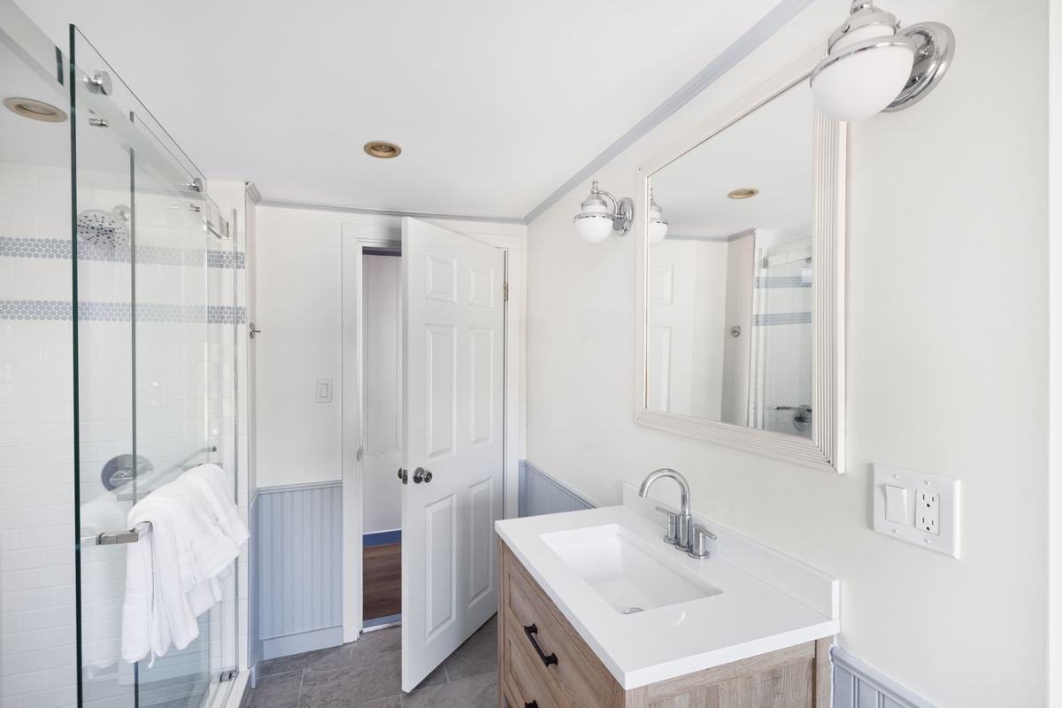 Shower in the upstairs bath with real water pressure and room to move — rinse the salt and the cove off properly, not just quickly.