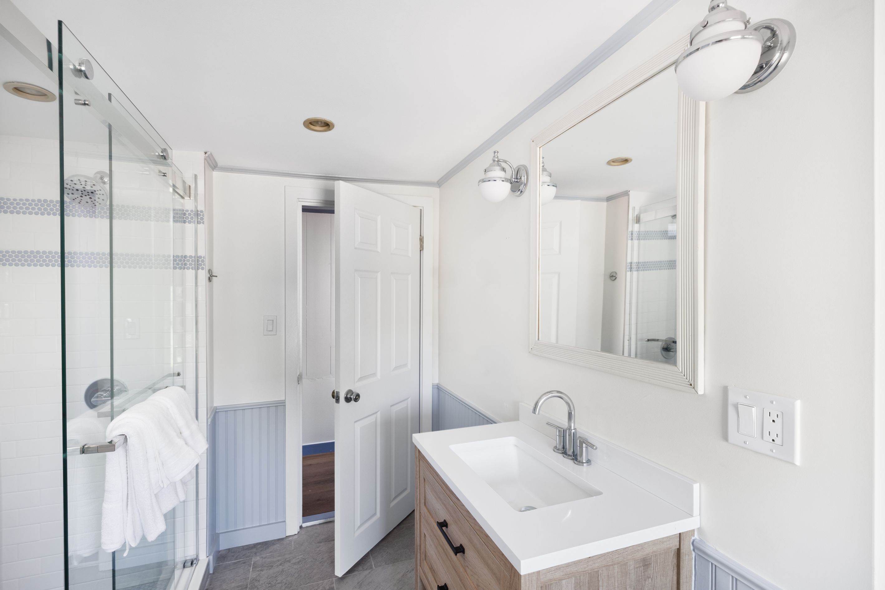 Shower in the upstairs bath with real water pressure and room to move — rinse the salt and the cove off properly, not just quickly.