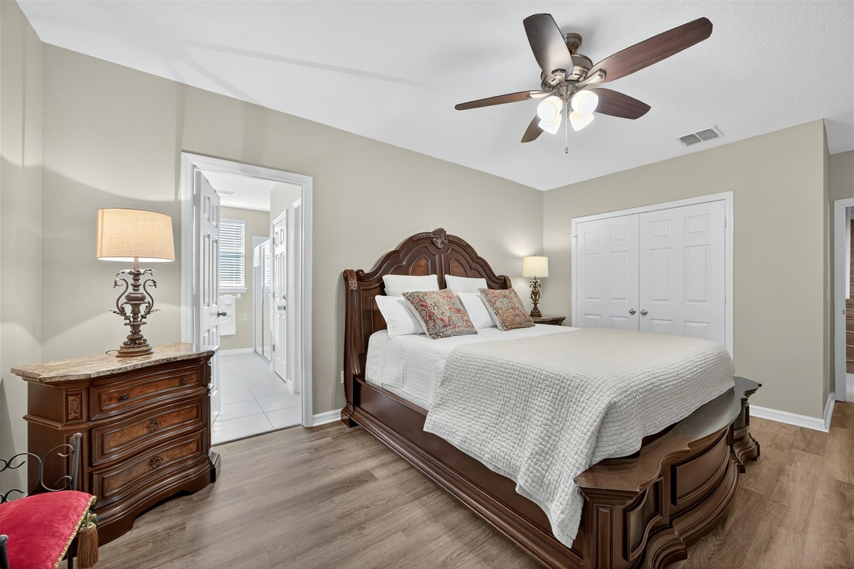Spacious master suite with TV, dresser, and luxurious ensuite bathroom.