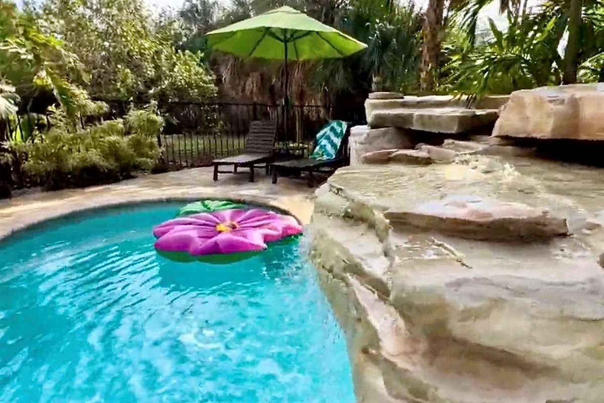 The pool waterfall is a featured amenity that stands out among the crowd!  The white noise it provides, paired with the tropical foliage surrounding it, simply can't be beat. 