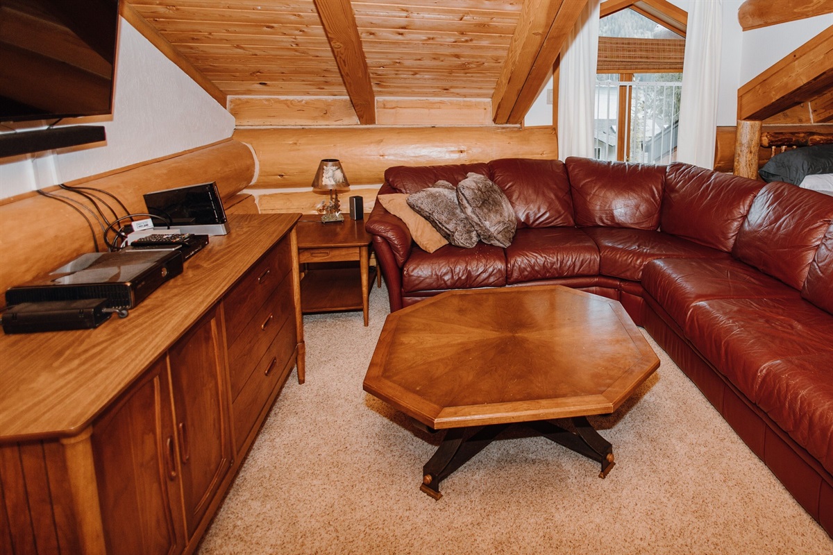 The living room on the third floor features an entertainment center.
