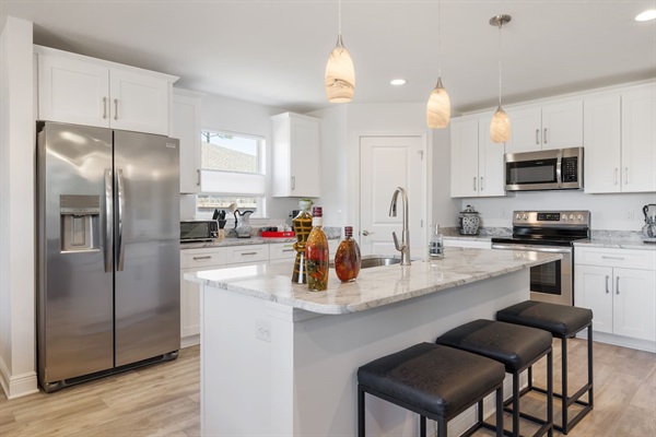 The kitchen includes a dishwasher, pans, plates, silverware, glasses, and plates and drinkware for kids.