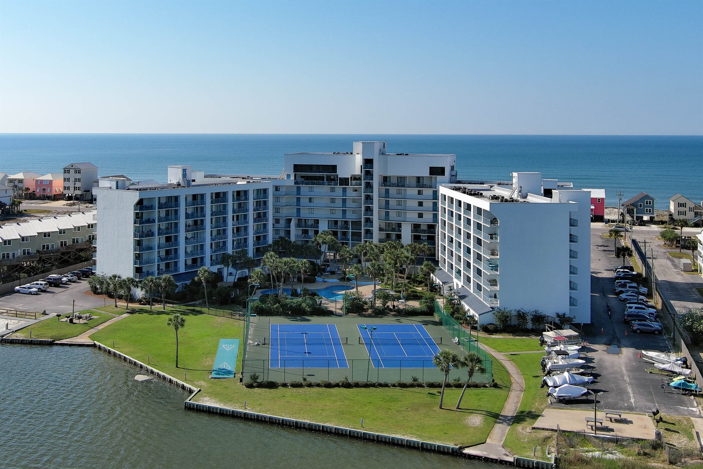 Perfect your serve on our professional tennis and pickleball courts overlooking the water at Surf and Racquet Club.