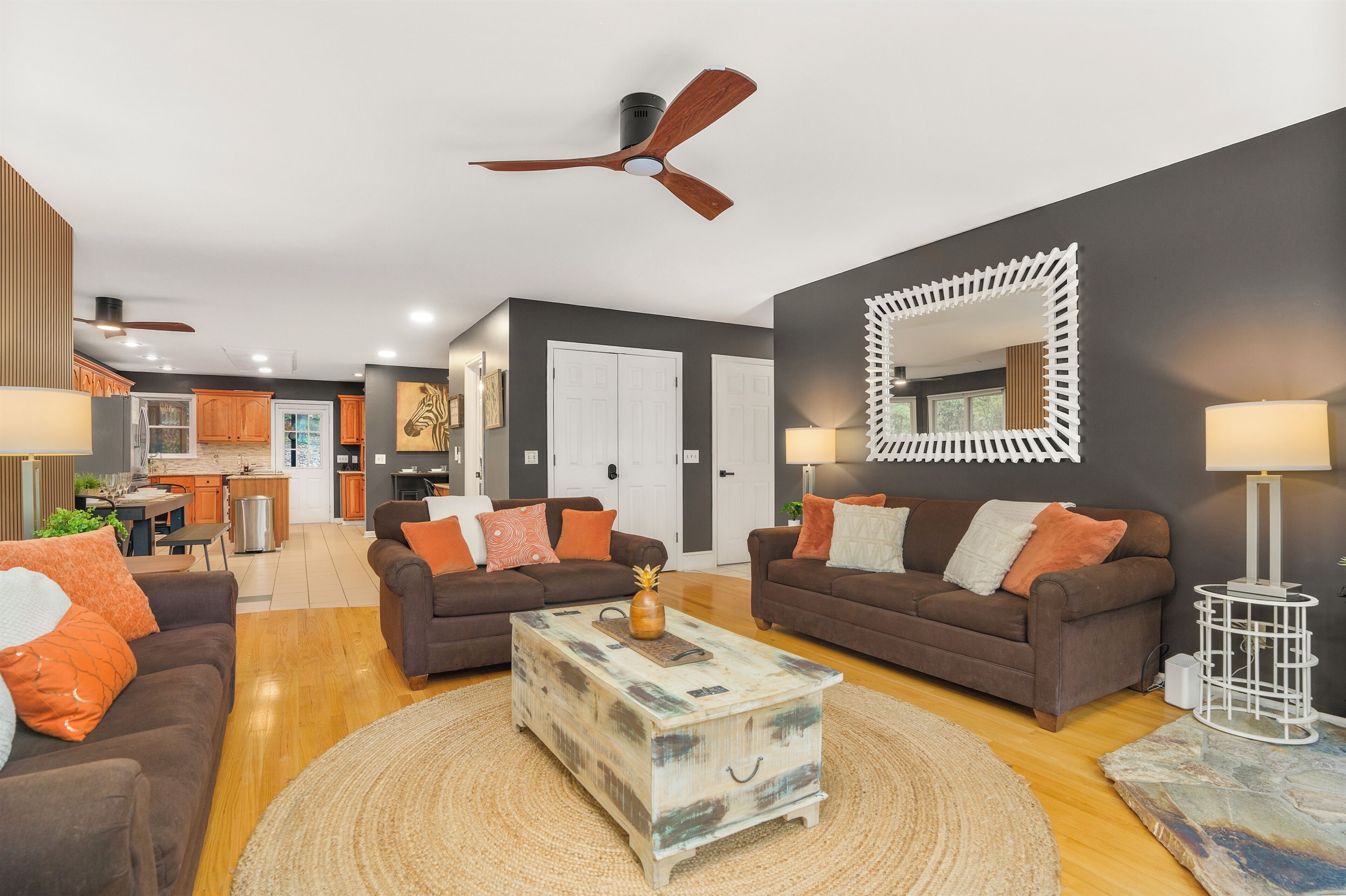Living room with large TV, electric fireplace, and ample seating
