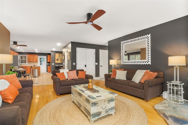 Living room with large TV, electric fireplace, and ample seating
