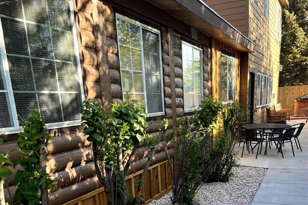 Restful, serene backyard area includes the hottub, additional eating areas and relaxing  patio swings and chairs for visiting together.