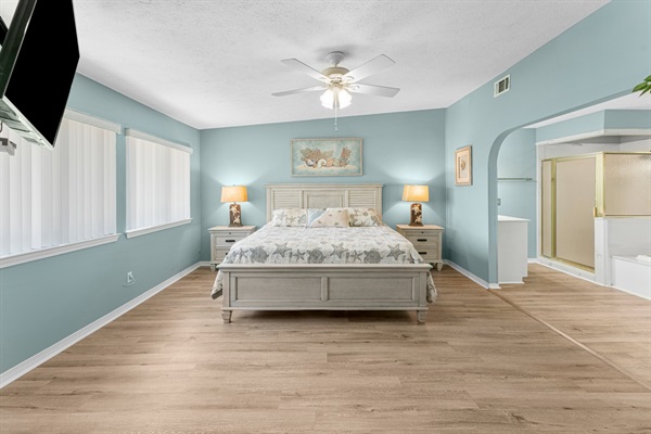 Bedroom #1 with king bed, ceiling fan, smart TV and ensuite bathroom