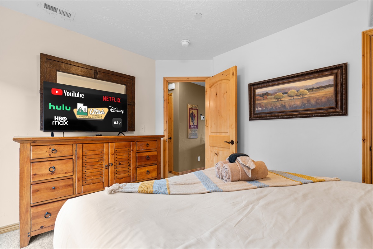 Second bedroom with dresser storage with a Smart TV.