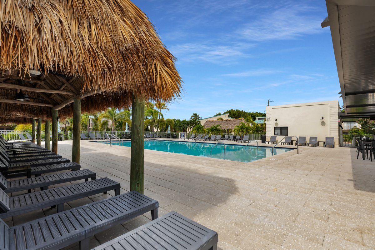 Brand new sparkling pool with tiki huts for shade